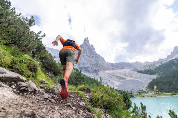 istock Man Trail Running Up Mountain Path with Rocky Peaks 2178305483
