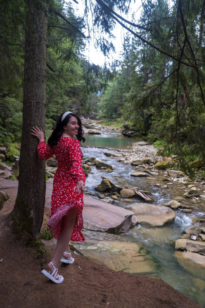 istock Woman in Red Dress by Serene Forest River 2178306946