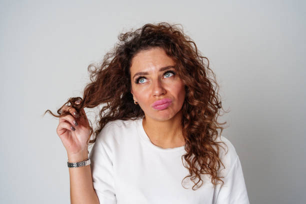 istock Confident woman with curly hair posed against a neutral background 2178307635