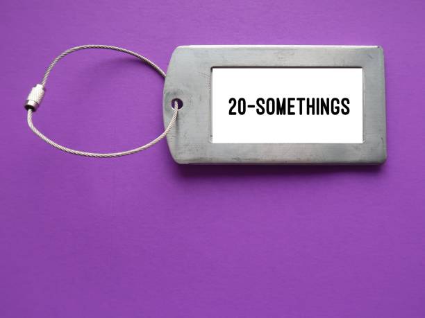 Luggage tag on blue background with text words 20 SOMETHINGS - unspecified age in twenties - person age between 20 and 29