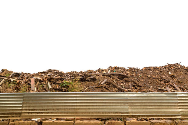 Construction waste with wood boards and other rubbish at construction site isolated on white background.