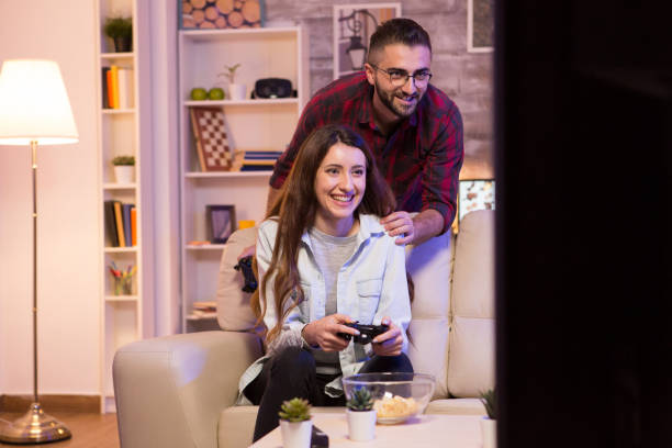 istock Happy young couple playing video games on television 2178310659