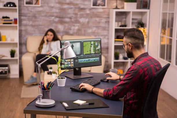 istock Creative videographer editing a movie on computer from home 2178310824