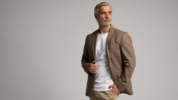 istock Serious middle-aged man posing in front of a grey background with copy space. 2178311853