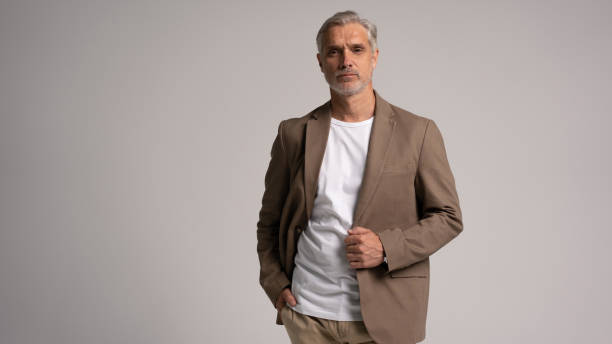 istock Serious middle-aged man posing in front of a grey background with copy space. 2178311859
