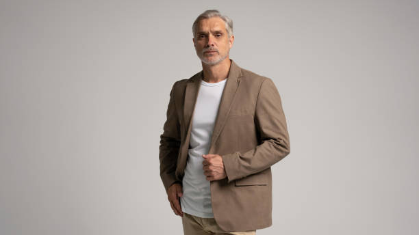 istock Serious middle-aged man posing in front of a grey background with copy space. 2178311861