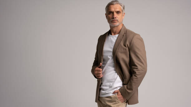 istock Serious middle-aged man posing in front of a grey background with copy space. 2178311862