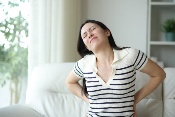 istock Asian woman suffering lumbago on uncomfortable couch 2178311888