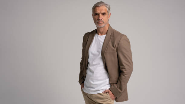 istock Serious middle-aged man posing in front of a grey background with copy space. 2178311933