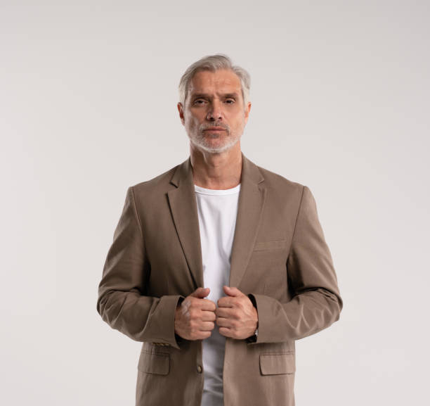 istock Serious middle-aged man posing in front of a grey background with copy space. 2178311949