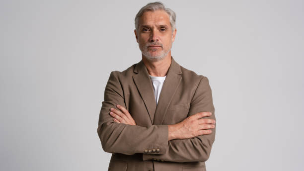 istock Serious middle-aged man posing in front of a grey background with copy space. 2178312002