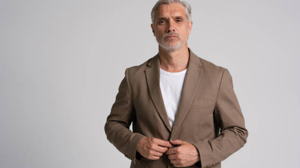 istock Serious middle-aged man posing in front of a grey background with copy space. 2178312004