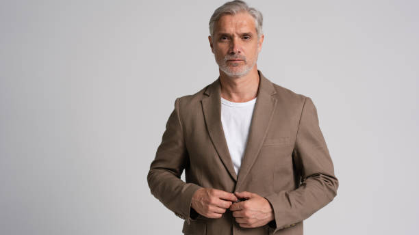 istock Serious middle-aged man posing in front of a grey background with copy space. 2178312006