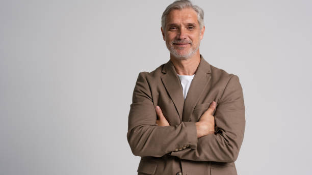 istock Serious middle-aged man posing in front of a grey background with copy space. 2178312017