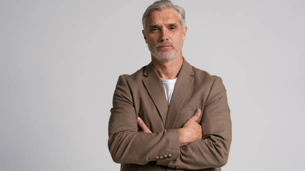 istock Serious middle-aged man posing in front of a grey background with copy space. 2178312019