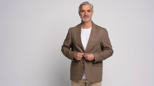 istock Serious middle-aged man posing in front of a grey background with copy space. 2178312028