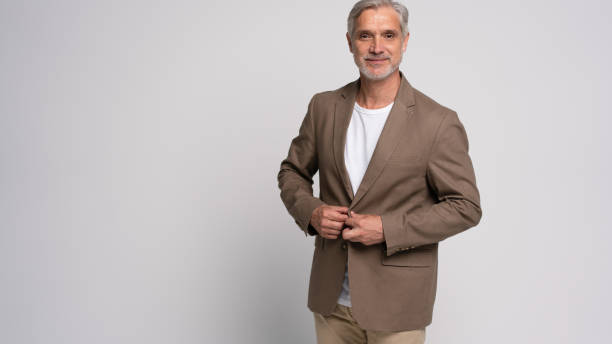 istock Serious middle-aged man posing in front of a grey background with copy space. 2178312038