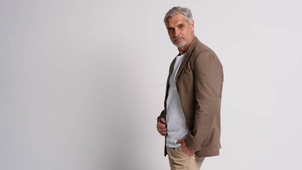 istock Serious middle-aged man posing in front of a grey background with copy space. 2178312039