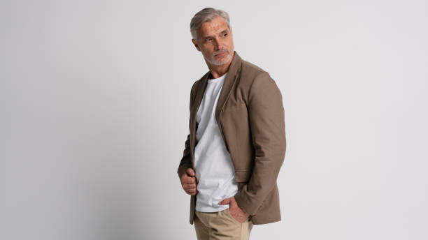 istock Serious middle-aged man posing in front of a grey background with copy space. 2178312042