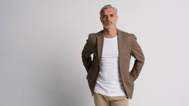 istock Serious middle-aged man posing in front of a grey background with copy space. 2178312047