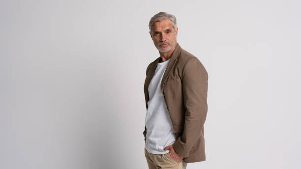 istock Serious middle-aged man posing in front of a grey background with copy space. 2178312055
