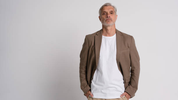 istock Serious middle-aged man posing in front of a grey background with copy space. 2178312064