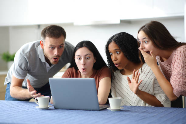 istock Four amazed roommates checking surprising news on laptop 2178312141