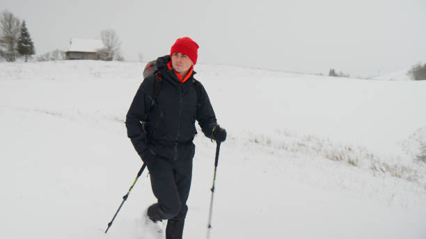 istock Male hiker ascends slope in winter 2178312481
