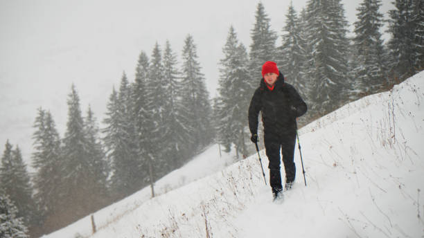 istock Male hiker ascends slope in winter 2178312530
