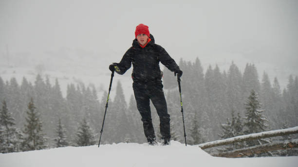 istock Male hiker ascends slope in winter 2178312544