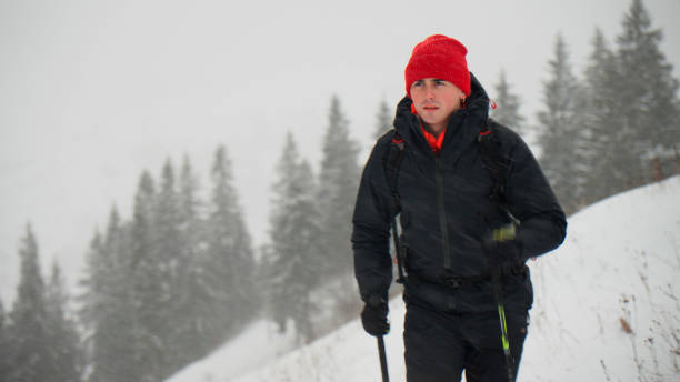 istock Male hiker ascends slope in winter 2178312560