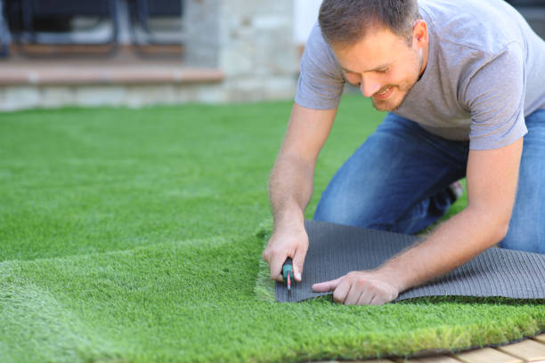 istock Happy man installing artificial lawn at home 2178312632