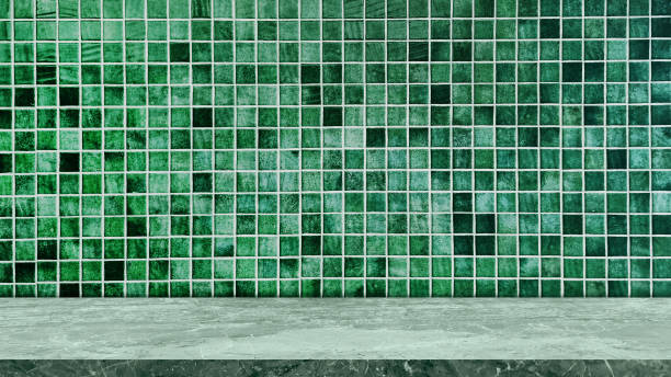 istock empty light green marble table top in foreground with square green mosaic tile at background. counter bar scene can be used for display or montage products. 2178312963