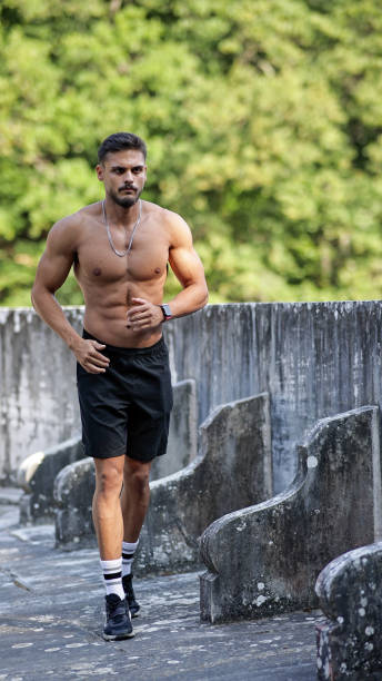 istock Muscular young man exercising outdoors, Young man doing running exercise, Man with beautiful body jogging naked, Muscular man with bare torso running outdoors, Morning exercises 2178314154