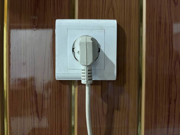istock electrical sockets mounted on glossy wood patterned PVC wall panels 2178316163