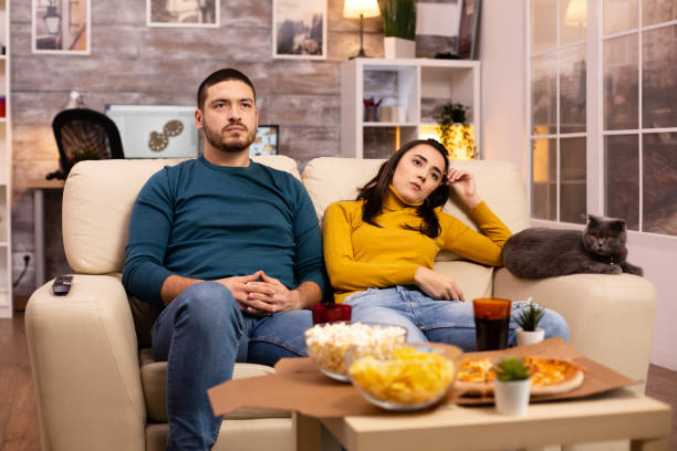 istock Couple cheering for their favourite team while watching TV 2178316346
