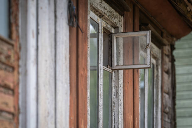 Open weathered window in wooden building. Grunge background.