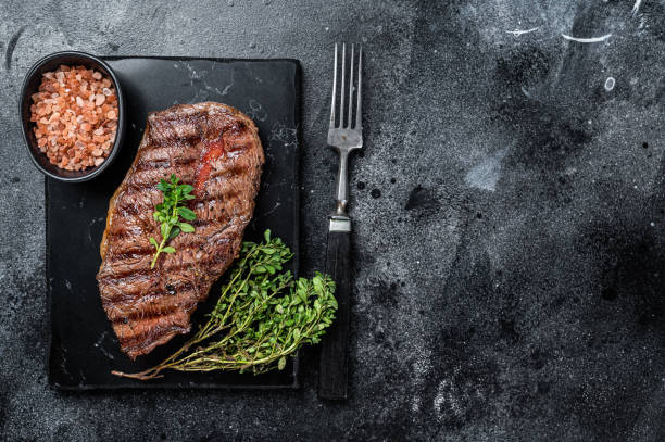 istock BBQ roasted Shoulder Top Blade or Australia wagyu oyster blade beef steak. Black background. Top View. Copy space 2178321614