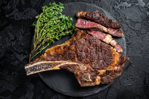 istock Roasted Tomahawk or cowboy with bone beef meat steak. Black background. Top view 2178321628