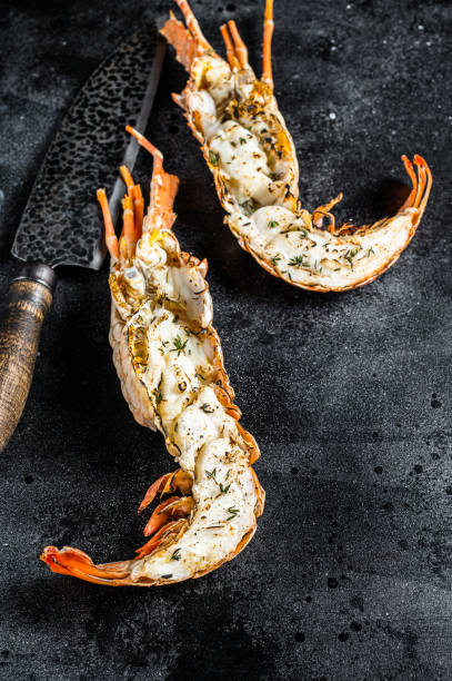 istock BBQ Grilled Spiny lobster sliced on a cutting board Black background. Top view 2178324267