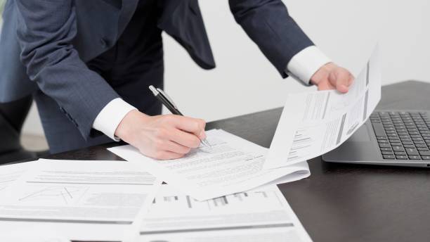 The hands of a businessman checking documents in a hurry stock photo