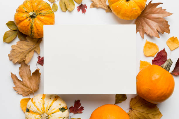 istock Autumn composition with paper blank and dried leaves with pumpkin on table. Flat lay, top view, copy space 2178327385