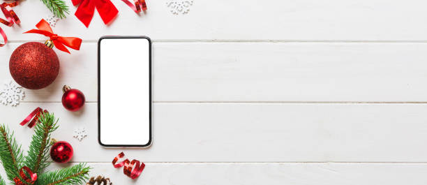 istock Digital phone mock up with rustic Christmas decorations for app presentation top view with empty space for you design. Christmas online shopping concept. Tablet with copy space on colored background 2178327390