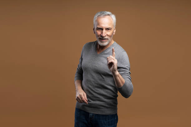 istock Senior man raising his index finger in a knowing gesture 2178327891