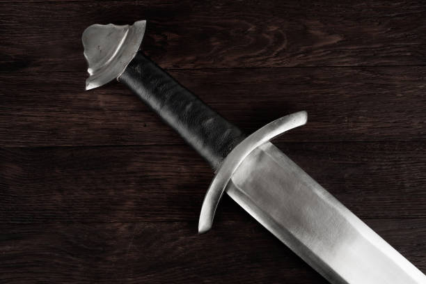 istock Medieval sword on wooden background. 2178327947