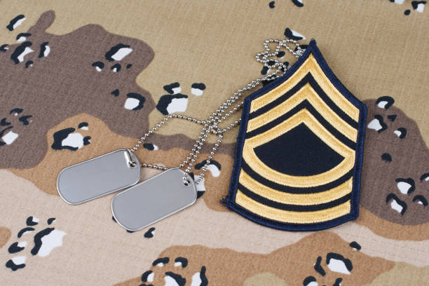 istock US ARMY Master Sergeant rank patch and dog tags on desert camouflage uniform 2178327968