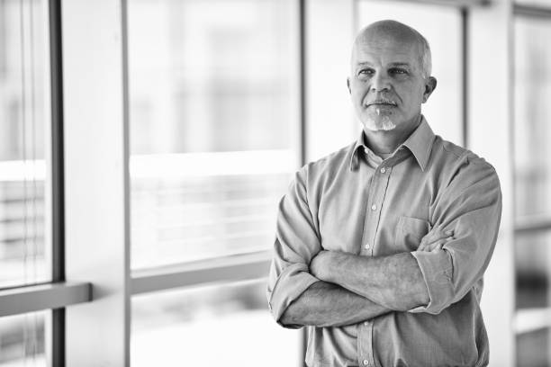 istock Senior manager standing with arms crossed in modern office 2178329505