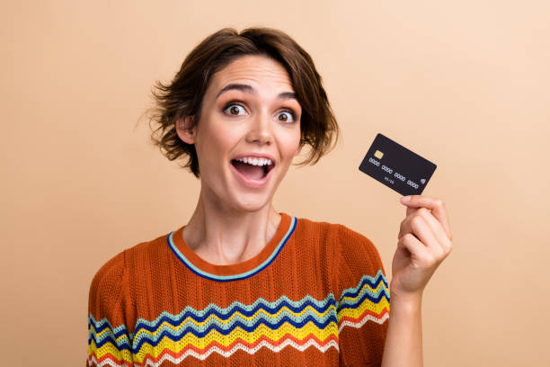 istock Portrait of impressed pretty person open mouth unbelievable hand hold plastic debit card isolated on beige color background 2178329708