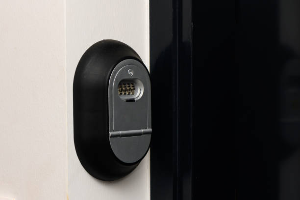 istock Key box with a combination lock next to the door and a bell button on the wall 2178330912