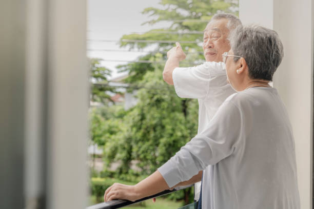 istock Two elderly individuals enjoy a light-hearted conversation and laughter on a balcony, sharing a peaceful and joyful moment in a relaxed outdoor setting, highlighting friendship and companionship. 2178331112